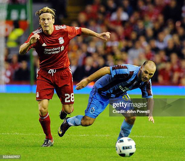 Christian Poulsen of Liverpool tussles with Serkan Balci of Trabzonspor AS during the UEFA Europa League, Play off, first leg Qualifying match...