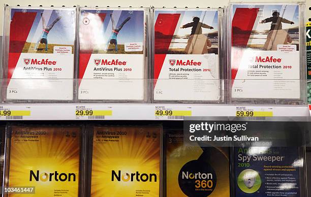 Boxes of McAfee security software are displayed alongside Norton Anti-virus software by Symantec on a shelf at a Target store August 19, 2010 in...