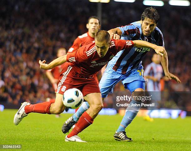 Joe Cole of Liverpool goes past Egemen Korkmaz of Trabzonspor during the UEFA Europa League, Play off, first leg Qualifying match between Liverpool...