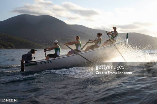 rowboat against high wave - rowing team stock pictures, royalty-free photos & images