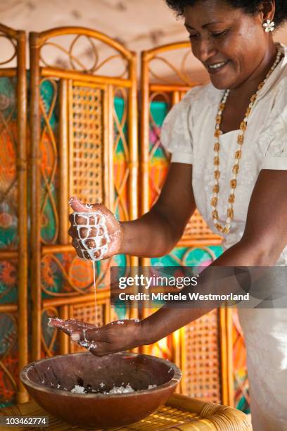 preparing coconut bath for spa treatment - pacific islands stock pictures, royalty-free photos & images