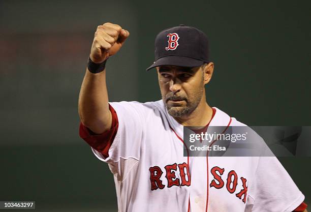 Mike Lowell of the Boston Red Sox celebrates as teammate J.D. Drew makes the catch for the final out of the third inning against the Los Angeles...