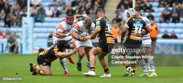 Leicester Tigers' Tom Youngs is tackled by Wasps' Ben Harris and Kieran Brookes during the Gallagher Premiership Rugby match between Wasps and...