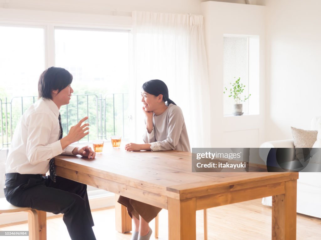 Young asian family talking in living room