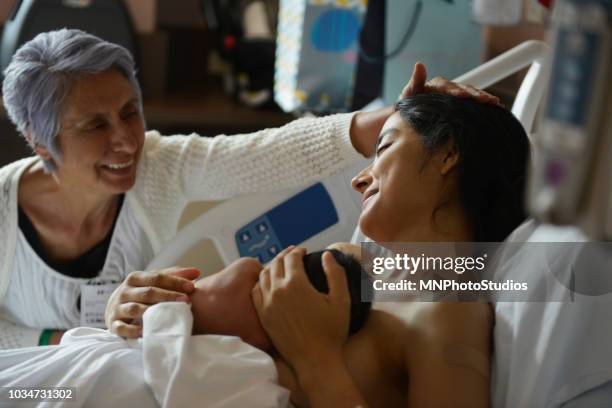 happy hispanic grandmother with daughter and newborn in a hospital - super mom stock-fotos und bilder