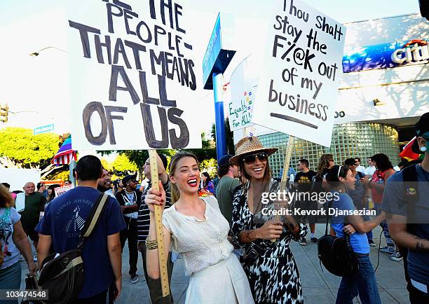 Actress Amber Heard holds a protest sign with her girlfriend Tasya Van Ree during a same-sex marriage advocates demonstration against the stay...