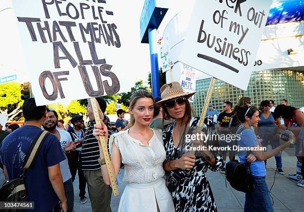 Actress Amber Heard holds a protest sign with her girlfriend Tasya Van Ree during a same-sex marriage advocates demonstration against the stay...