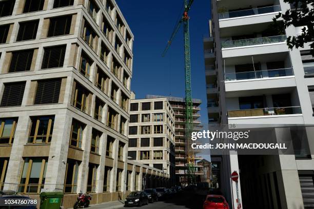 Newly-built office buildings are seen near the so-called East Side Gallery, a 1,3 km-long stretch of the Berlin wall, on September 17, 2018. - The...