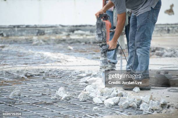 construction worker with hammer drill - heavy demolition stock-fotos und bilder