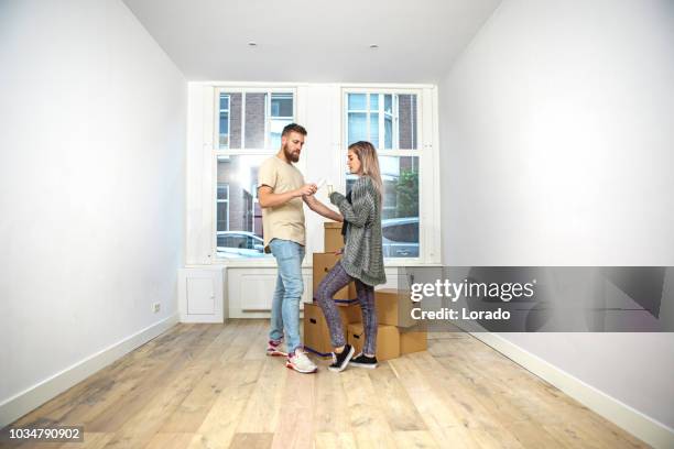young couple moving into a new house - homeowners insurance stock pictures, royalty-free photos & images