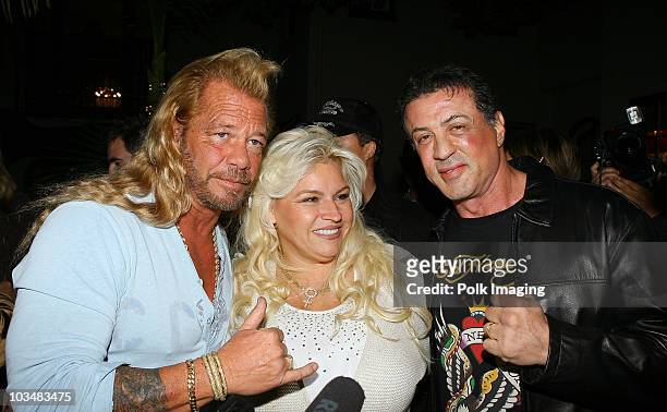 Personalities Beth Smith, Duane 'Dog' Chapman and actor Sylvester Stallone attend the Ed Hardy Swimwear launch fashion show held at Christian...