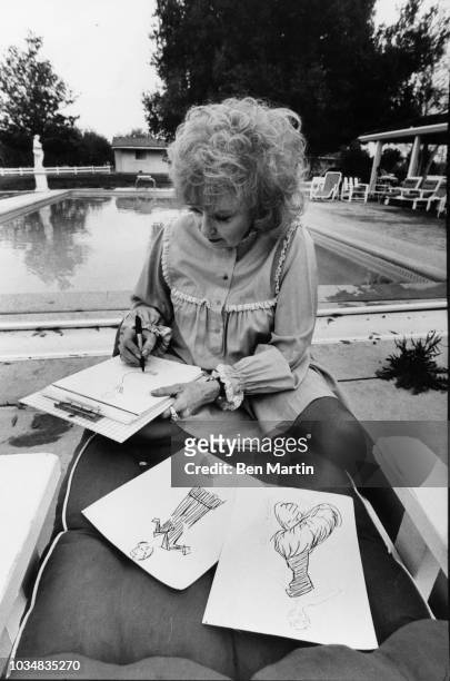 Edie Adams , comedienne and singer, at her home on an almond ranch sketching fashions for her line of Bonham label party gowns sold at Neiman-Marcus...