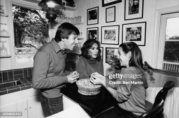 Gary Collins , actor, and wife Mary Ann Mobley , former Miss America with daughter Clancy in the kitchen, December 9th, 1980.