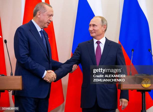 Russian President Vladimir Putin shakes hands with Turkish President Recep Tayyip Erdogan after their joint press conference following the talks, in...