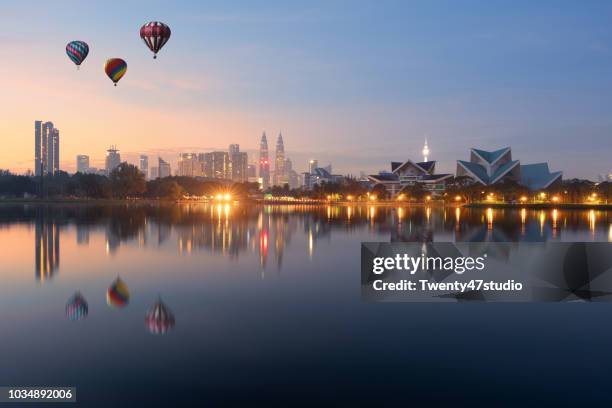 hot air balloon over kuala lumpur skyline, titiwangsa park in malaysia. - kuala lumpur landscape stock pictures, royalty-free photos & images