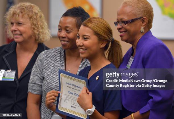 Kendra Montano stands with teachers and Goodwill staff as she and nine other recent high school graduates received their Certified Nursing Assistant...