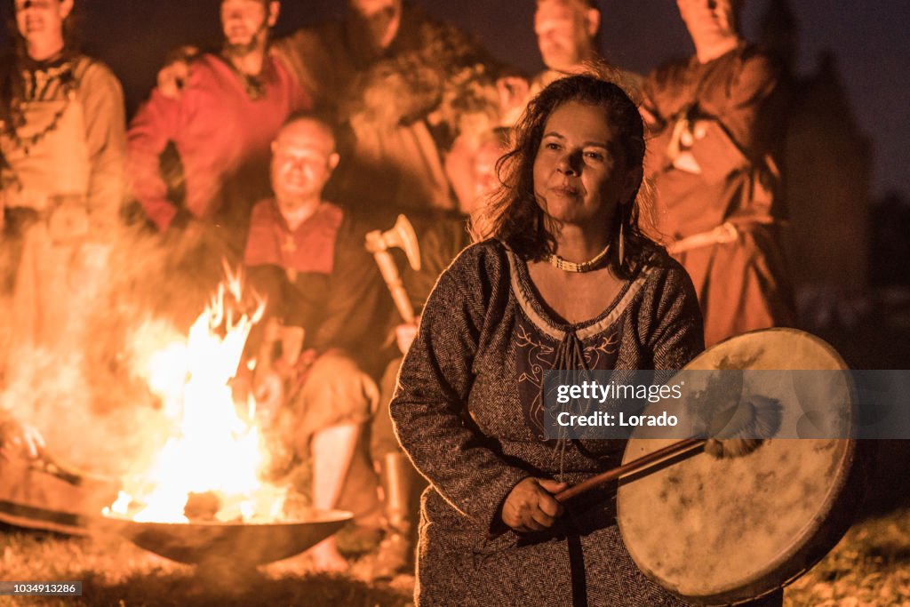 Woman in front of a Viking campfire