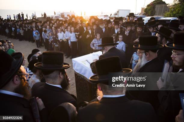 Ultra-Orthodox Jews of the Vizhnitz dynasty listen to their Rabbi as they gather on a beach near the Mediterranean Sea to practice the Tashlich...