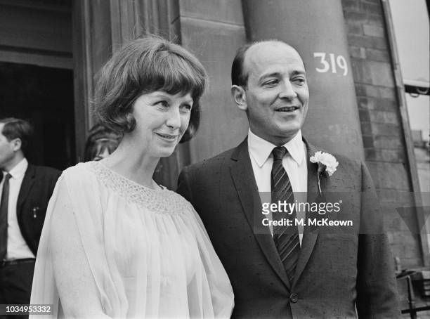 Czech born British filmmaker Karel Reisz pictured with his wife, American actress Betsy Blair outside a register office on their wedding day in...