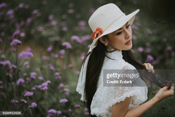 asian woman traveling at flower farm - floral dress stock pictures, royalty-free photos & images