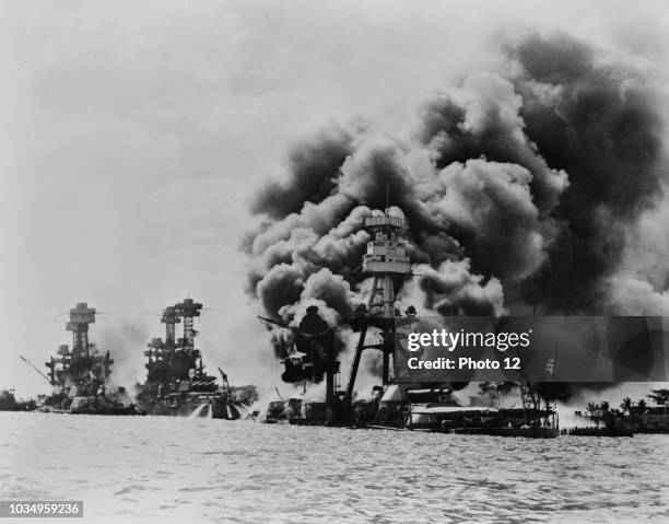 Three stricken US battleships, left to right: USS West Virginia, USS Tennessee and USS Arizona after the Japanese attack on Pearl Harbor, World War...