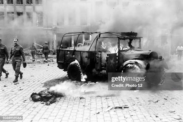Photograph of the death and damaged caused by a German V-2 rocket exploding on a main intersection. Antwerp, Belgium. Dated 1944.