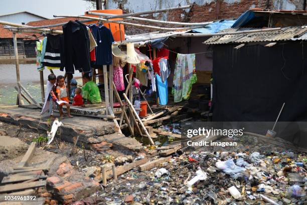 living in indonesia - jakarta slum stock pictures, royalty-free photos & images