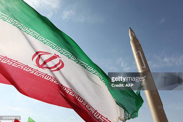 Picture taken on August 20, 2010 shows an Iranian flag fluttering at an undisclosed location in the Islamic republic next to a surface-to-surface...