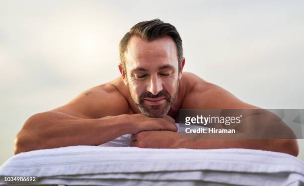 relaxation at its best - man massage stock pictures, royalty-free photos & images