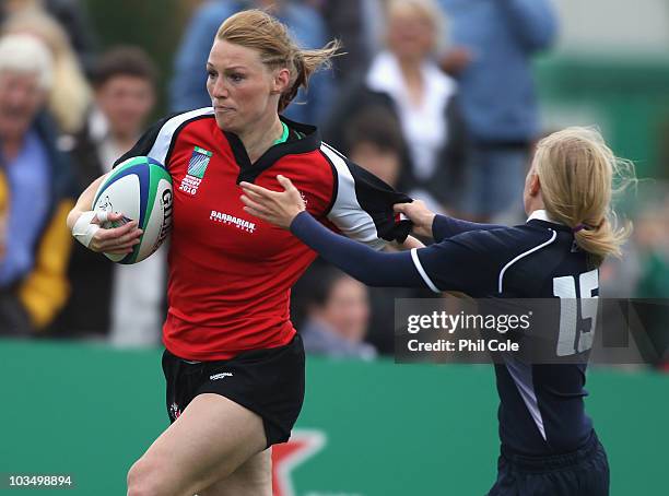 Heather Moyse of Canada goes past Nicola Halfpenny of Scotland and scores a try during the Women's Rugby World Cup 2010 Pool C Match between Canada...