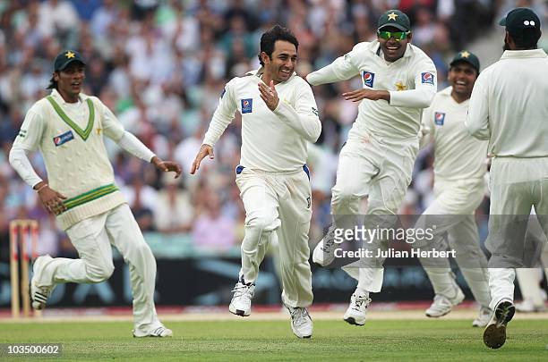 Saeed Ajmal of Pakistan celebrates the wicket of Eoin Morgan of England with team mates during day three of the npower 3rd Test Match between England...