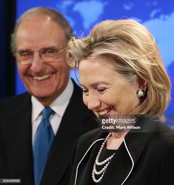 Secretary of State Hillary Rodham Clinton smiles while flanked by Special Envoy for Middle East Peace Talks, Senator George Mitchell , while briefing...