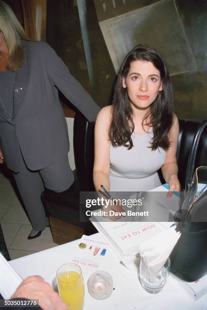 Journalist, TV presenter and food writer, Nigella Lawson signing copies of her her first cook book, 'How To Eat', at the book's launch party at the...