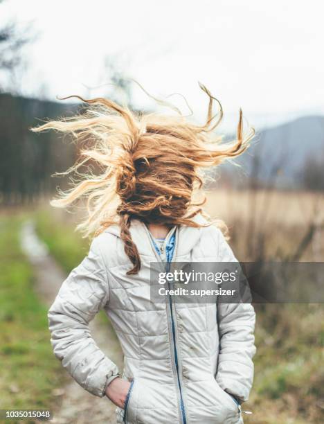 young girl and wind through her ginger hair - air serbia stock pictures, royalty-free photos & images