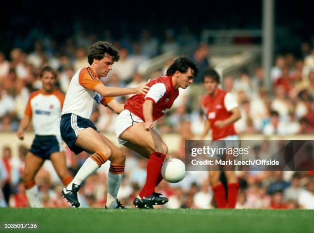 August 1983 London - Football League Division One - Arsenal v Luton Town - Charlie Nicholas of Arsenal shields the ball from Luton defender Mal...