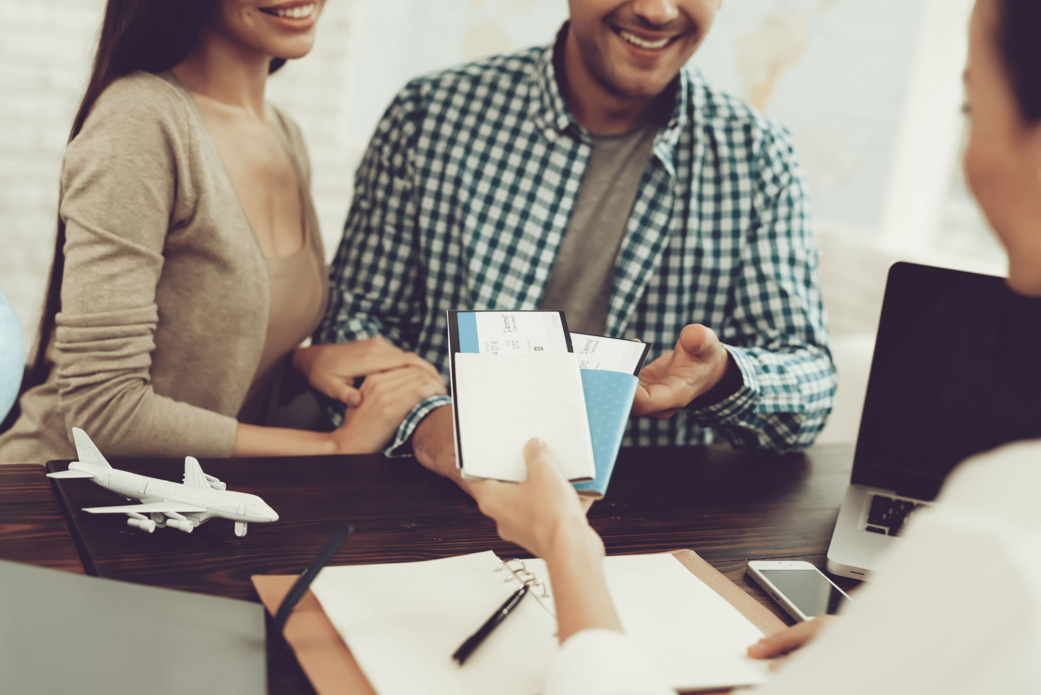 Manager in Travel Agency Giving Tickets To Couple. Manager in Travel Agency Giving Tickets To Couple.