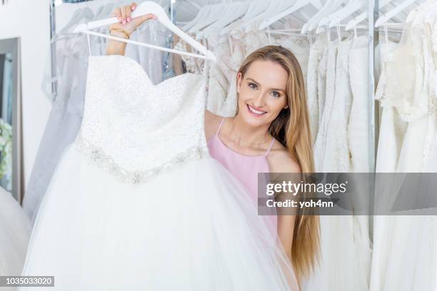 woman choosing wedding dress - wedding dress on hanger stock pictures, royalty-free photos & images