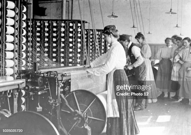 Photograph of young woman at spinning machine in cotton mill. Mollahan Mills, Newberry, South Carolina. Dated 1908.