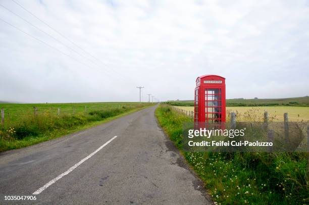 red telephone box at houton, orkney, scotland - british culture stock-fotos und bilder
