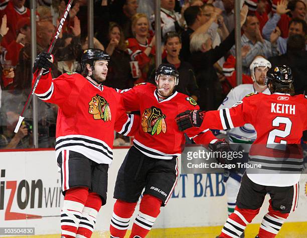 Chicago Blackhawks' Brent Seabrook celebrates his goal against the Vancouver Canucks with teammates Kris Versteeg and Duncan Keith during the first...