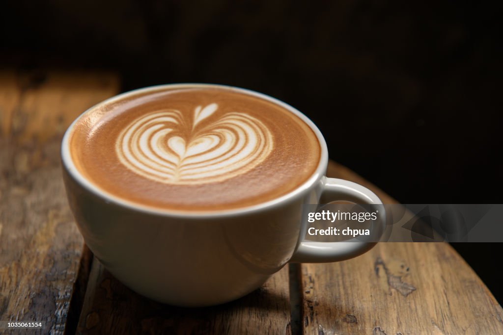 A cup of latte on wooden table