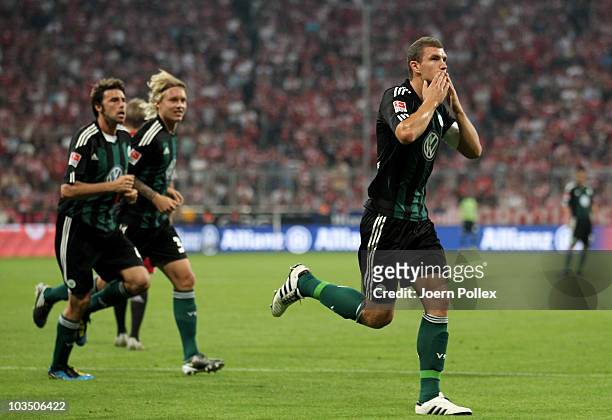 Edin Dzeko of Wolfsburg celebrates after scoring his team's first goal during the Bundesliga match between FC Bayern Muenchen and VfL Wolfsburg at...