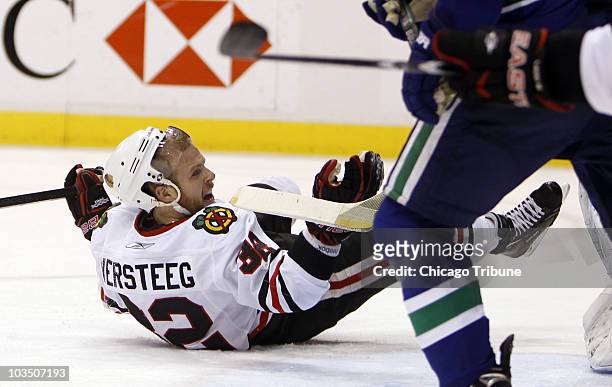 Chicago Blackhawks' Kris Versteeg disputes a non-call after being knocked to the ice in the first period against the Vancouver Canucks in Game 6 of...