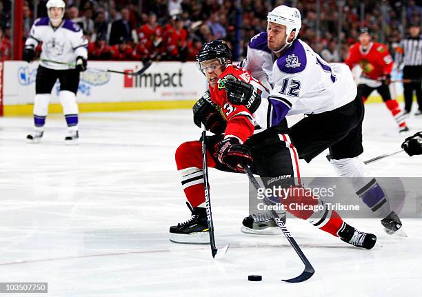 Chicago Blackhawks' Kris Versteeg feels the pressure from Los Angeles Kings' Randy Jones in the first period of NHL action at the United Center in...