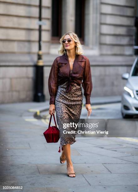 Anne-Laure Mais wearing animal print skirt, brown blouse, sandals, bordeaux bag is seen outside Erdem during London Fashion Week September 2018 on...