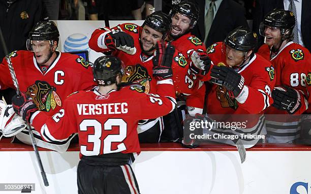 The Chicago Blackhawks' Kris Versteeg is welcomed back to the bench after scoring empty net goal against the San Jose Sharks during the third period...