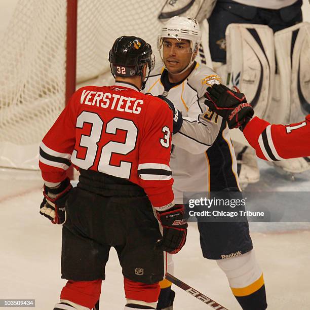 Chicago Blackhawks' Kris Versteeg confronts Nashville Predators' Francis Bouillon during the first period in Game 2 of the NHL Western Conference...