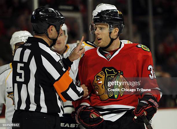 Chicago Blackhawks' Kris Versteeg is scolded by referee Chris Rooney in Game 2 of the NHL Western Conference playoffs against the Nashville Predators...