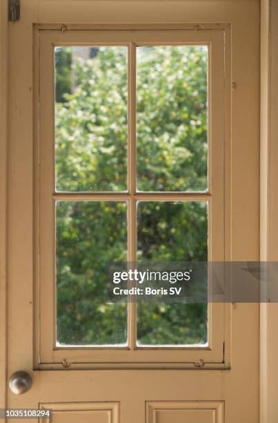 old balcony door looking into backyard - window frame stock pictures, royalty-free photos & images
