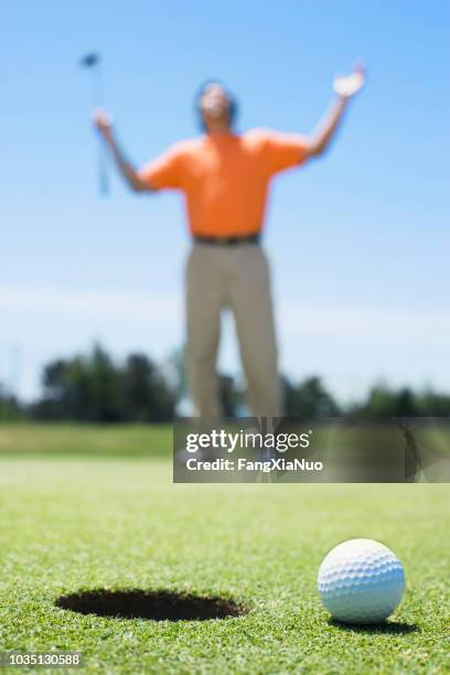 frustrated asian man on golf course - cross golf stock pictures, royalty-free photos & images